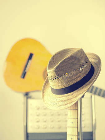 Straw hat on an electric vintage guitar in a studioの写真素材