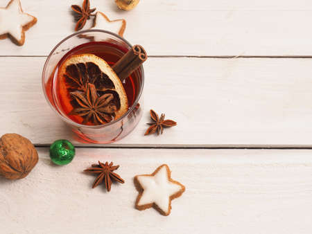 Glass of mulled wine on a white wooden table with space for text, view from aboveの写真素材