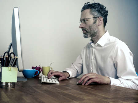 Overwork, deadline business concept, businessman typing on computer at night officeの写真素材