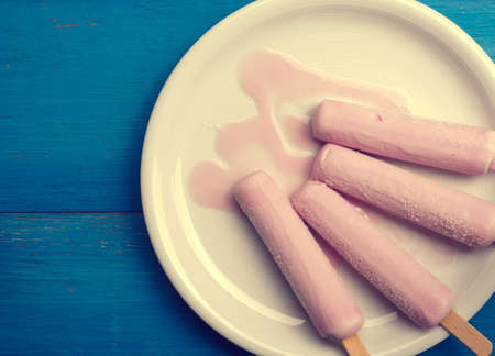 Strawberry ice cream on a blue wooden backgroundの写真素材