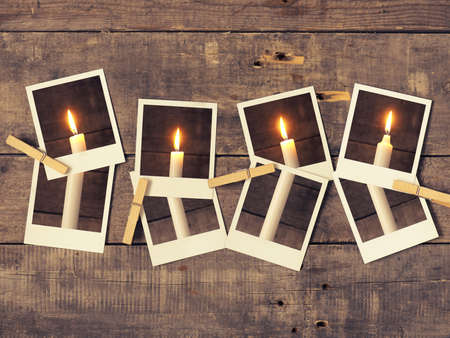 Old instant photograph with four candles on a rustic wooden background, Advent concept background retro film stylizedの写真素材