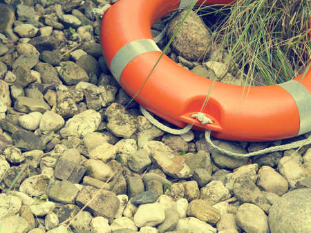 Rescue belt on natural pebbles background with space for text or image