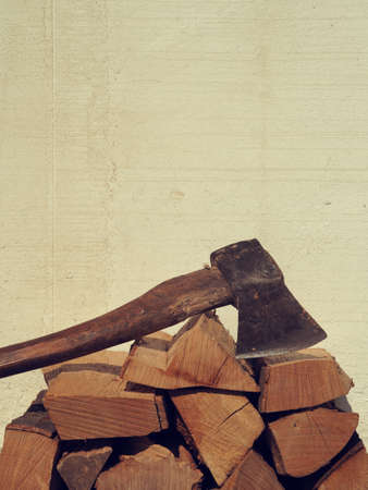 Pile of beech fire wood with an old axe, alternative energyの写真素材