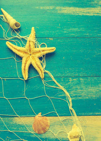 Old weathered wood texture with a fishing net, seafood restaurant or travel vacation concept backgroundの写真素材