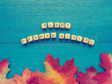 Blue weathered wood with red leaves, thanksgiving or seasonal fall backgroundの写真素材