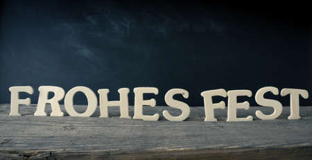 Old chalkboard with the German words Merry Christmas, holiday concept background