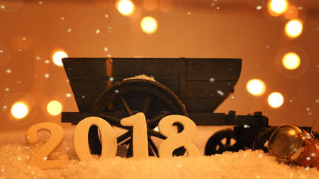 New Years concept with an old cart and bottle cork in snow, wooden number 2018の写真素材