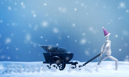 Wooden puppet with an old wooden cart deliver a Christmas treeの写真素材