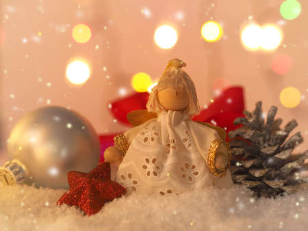 Christmas background with an angel and decoration in snowの写真素材