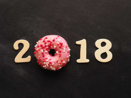 Sweet pink donut with the number 2018, sweet New Year concept
