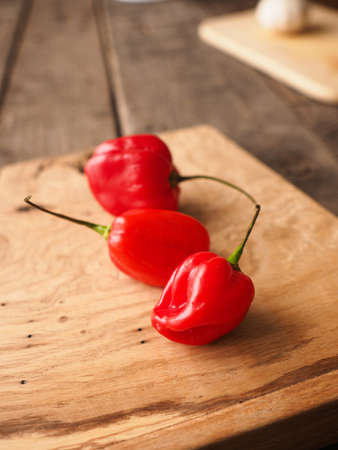 Hot and spicy Habanero chili on rustic woodの写真素材