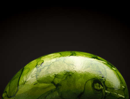 Close uo of a green Easter egg on a dark background, Happy Easter backgroundの写真素材