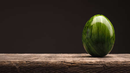 Green Easter egg on a rustic wooden table, Happy Easter backgroundの写真素材