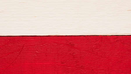 Polish flag on rustic wood using as background with space for text or imageの写真素材