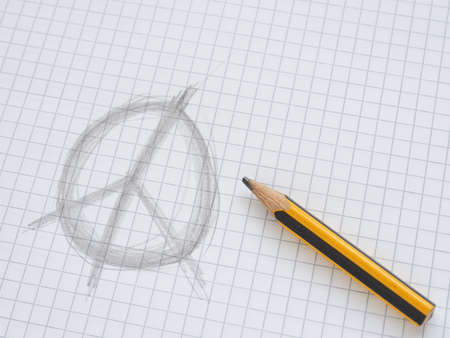 Hand drawn peace sign on checkered paper with a pencil and space for textの写真素材