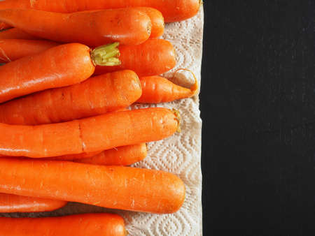 Fresh organic carrots on a kitchen table, healthy eating background with space for textの写真素材