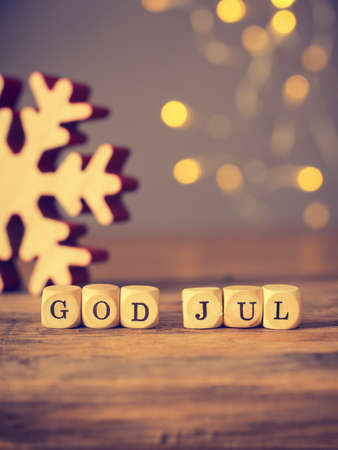 God Jul, Scandinavian Merry Christmas on wooden dices, seasonal background vintage color stylizedの写真素材