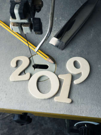 New Year concept with a wooden 2019 on a electric sawの写真素材