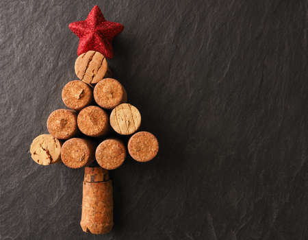 Abstract Christmas tree of bottle cork on a dark slate background with space for textの写真素材