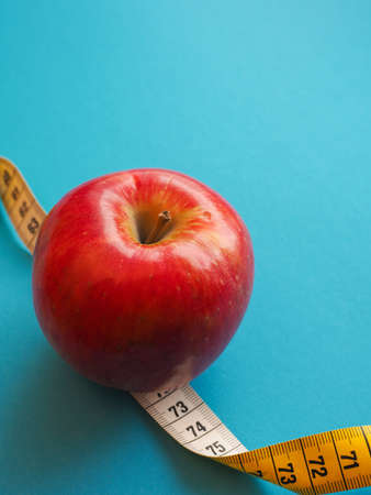 Diet or healthy eating concept with a measuring tapeの写真素材