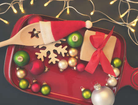 Christmas decoration on a plate with cooking spoon and gift box