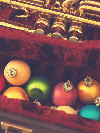Colorful vintage Christmas baulbes with an old used trumpet, Christmas music backgroundの写真素材