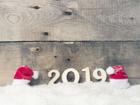 Merry Christmas and a happy New Year 2019, with snow and hat of Santaの写真素材