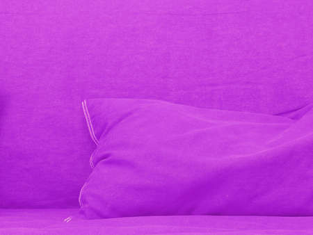 Pink couch with pink pillow close up shot, conceptual interior background