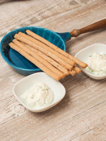 Fresh organic cream cheese with chives and parsley served with organic spelt sticks