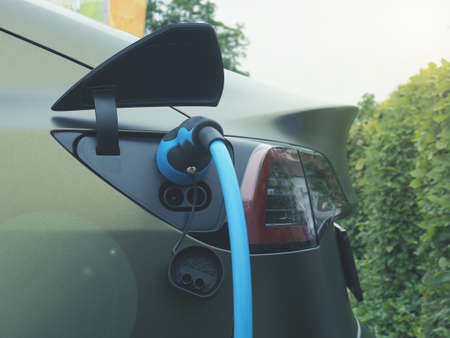 Closeup of an electric car at a charging stationの写真素材