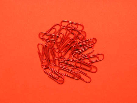 Red paperclips on a red backgroundの写真素材