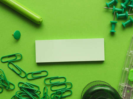 Office utensils on a green background with space for textの写真素材