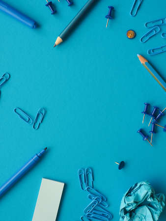 Office utensils on a blue background with space for textの写真素材