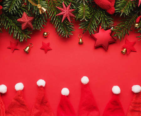 Traditional Christmas background with twigs of a fir tree and red Christmas decoration