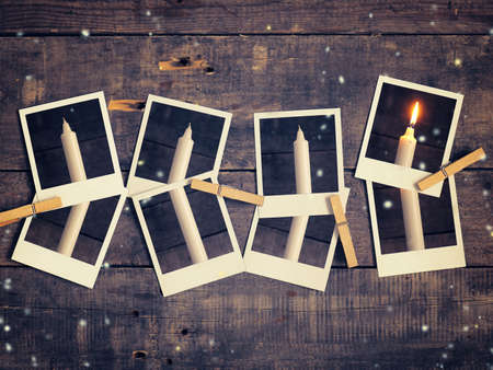 Old instant photograph with four candles on a rustic wooden background, Advent concept background retro film stylizedの写真素材