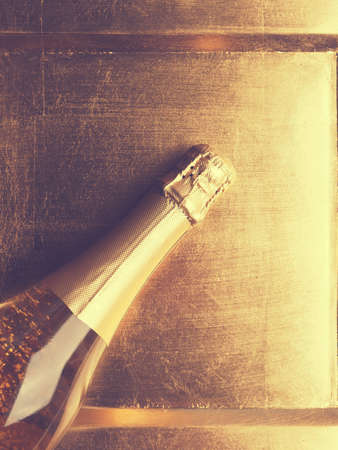Golden champagne on a golden plate, Happy New Year concept background, vintage color stylizedの写真素材