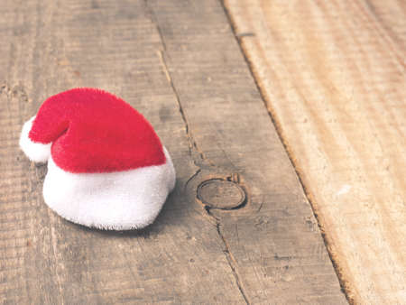 Hat of Santa on a rustic wooden plank with space for textの写真素材
