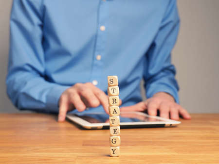 Business concept with small wooden blocks on an office tableの写真素材