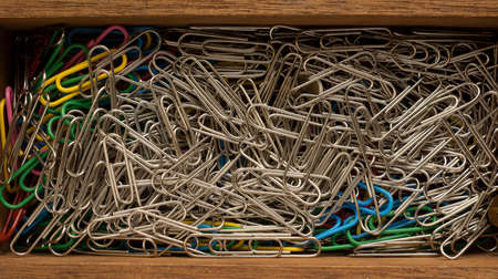 Close up of paper clips in a wooden box, office utensils, high resolution shot