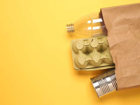 Paper bag with recyclable consumer goods such as plastic bottle, tin can, waste paper and waste...