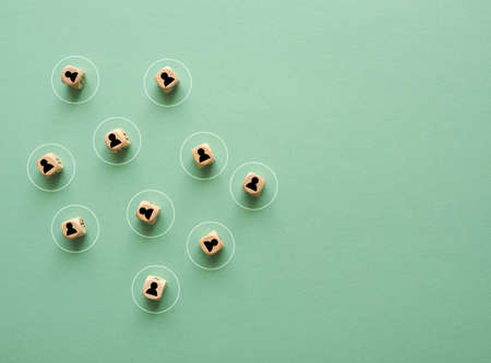 Small wooden blocks with character icons and a circle around them as a symbol for social distanceの写真素材