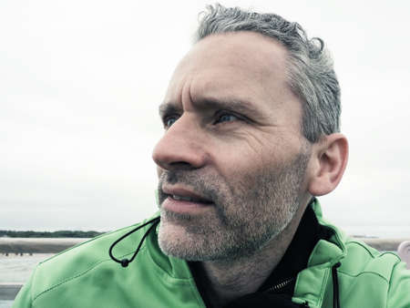 Portrait of a middle-aged man looking skeptically to the sideの写真素材