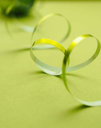Shiny green ribbon on a green background, Christmas decoration backgroundの写真素材