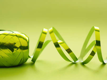 Shiny green ribbon on a green background, Christmas decoration background