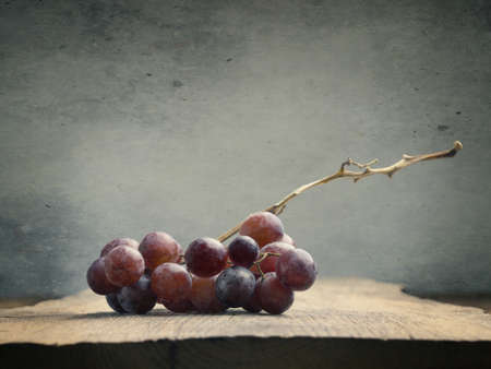 Fresh organic grapes on a wooden tableの写真素材