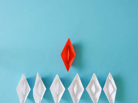 Leadership or Teamwork business concept with paper boat on a blue paper background with space for textの写真素材
