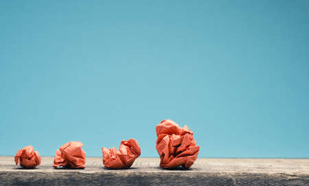 New ideas or teamwork concept with crumpled paper balls on a wooden table
