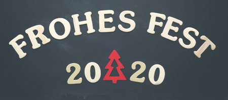 Old chalkboard with the German words Merry Christmas 2020, holiday concept backgroundの写真素材
