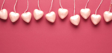 10 heart hanger in a row on red background with space for your text or images