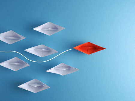 New ideas, creativity and various innovative solutions or leadership concept paper boats on a blue...